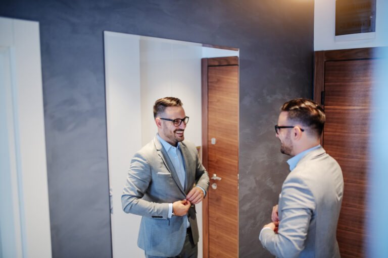 Man in suit practicing interview skills in front of the mirror