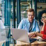 man and woman with lap top tracking progress towards goals